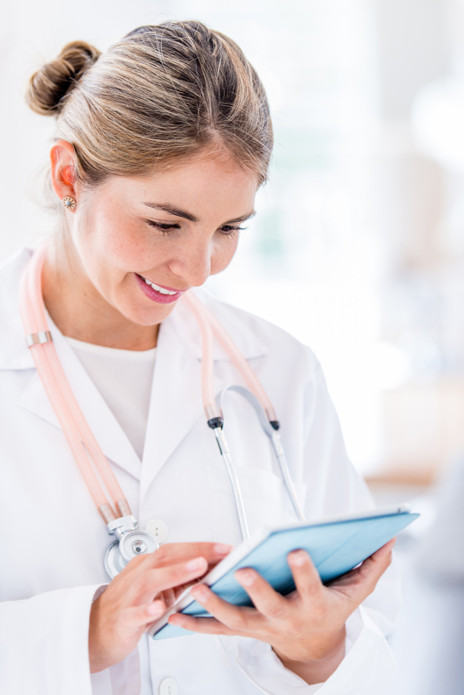 Female doctor using app on a tablet computer